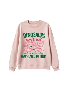 Close-up view of the cute dinosaur graphic and funny slogan printed on the pink sweatshirt.