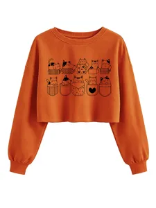 Orange cropped sweatshirt detail featuring cute black outline cats in boxes and pockets.