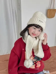 Kids winter knit scarf hat detail, cozy white wool beanie with cute pom pom for cozy daily wear.