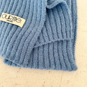 Close-up detail of soft blue kids knitted rib neck warmer scarf showing textured fabric.