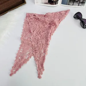 Detailed view of pink hollow lace triangle scarf, featuring delicate floral knit pattern and cute edge.