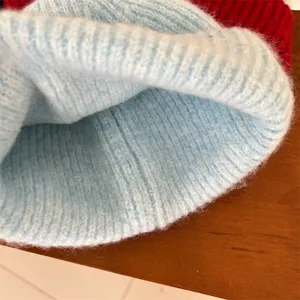Light blue knit beanie hat close up, soft fluffy winter warm knitwear accessory detail view.