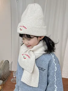 Kids knit beanie and scarf set with cute embroidery, soft warm winter wool accessory.