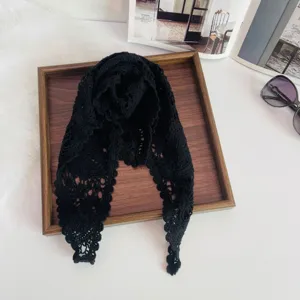 Black crochet lace triangle scarf, delicate knit headscarf detail view, vintage aesthetic design.