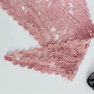 Detailed view of pink hollow crochet lace triangle scarf, showing delicate knitted texture.