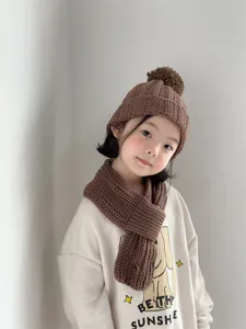 Children brown knit hat and scarf set, warm winter wool pompom beanie for kids daily wear.