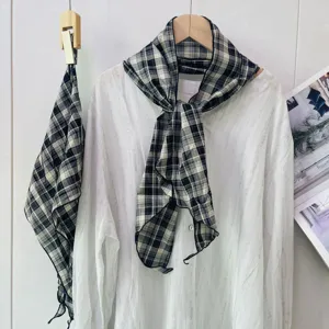 Detail view of a vintage black and white plaid neck scarf, elegant spring summer accessory.