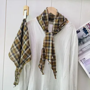 Detailed view of vintage plaid scarf neckerchief showcasing retro brown pattern design.