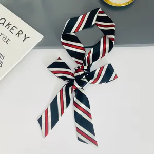 Detailed view of a chic black, white and red striped hair ribbon scarf for elegant styling.