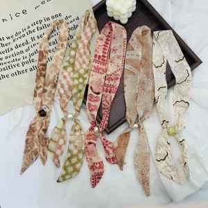 Close up of vintage floral silk scarf with pearls, delicate beaded texture detail.
