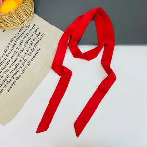 Detailed view of a solid red long thin satin ribbon scarf, perfect for bag handles or hair styling.
