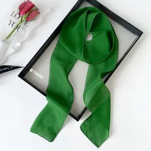 Green thin silk ribbon scarf detail view, elegant accessory for bags or hair styling.