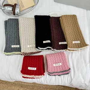 Close-up of kids cable-knit scarf details, featuring multi-color wool neckerchief assortment.