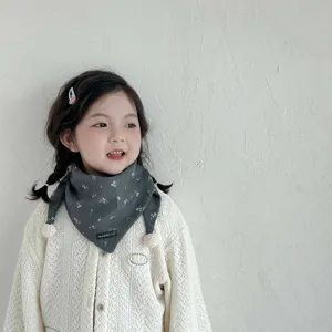 Thick windproof toddler floral triangle scarf with cute pom-pom tassels detail view.