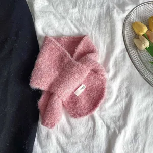 Pink fuzzy circle scarf for kids, cross neck warmer detail view, soft knitted winter accessory.