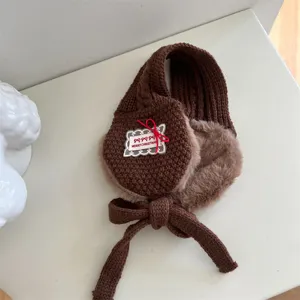 Kids winter warm knitted earmuffs in brown with cute bow design and plush lining for cold weather.