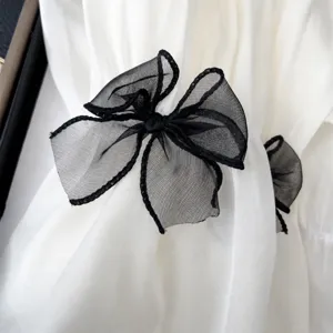 Manches de protection solaire d'été respirantes avec élégants détails de nœud papillon en tulle.