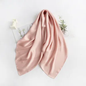 Delicate pink silk square scarf close-up detail, soft and elegant drapery with botanical props.