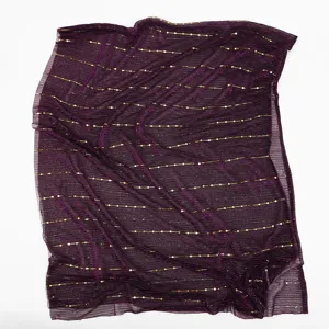 Detailed view of the deep purple sparkling sequin gauze scarf fabric texture and gold dot design.