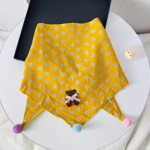 Cute kids yellow triangular scarf with cute rabbit prints, colorful pom poms, and bear decor.