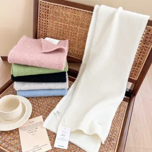 Cozy solid color knit scarf detail showing soft texture, multi-color stack and elegant style.