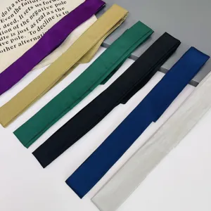 Close-up detail of smooth satin long narrow ribbon scarf, perfect for bag handle wrap.