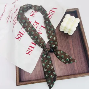Detailed shot of retro floral skinny scarf with black bead necklace for women fashion.