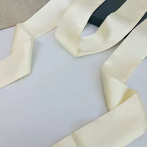 Detailed shot of a solid color satin silk ribbon, perfect for bag handles or hair styling.