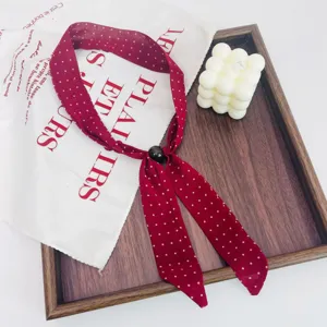Vintage red polka dot ribbon scarf necklace with beaded detail, elegant retro neck accessory.