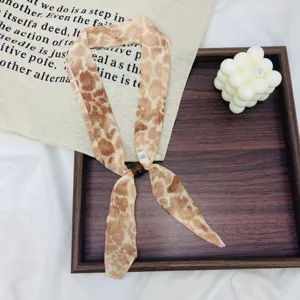 Retro leopard print skinny scarf with bead detail, stylish versatile neck scarf accessory.