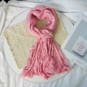 Detailed view of the pink pleated chiffon scarf, delicate texture and soft fabric.