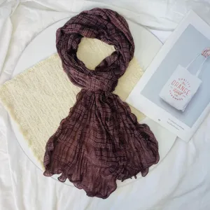 Detailed view of the dark brown crinkled chiffon scarf, lightweight and elegant for summer.