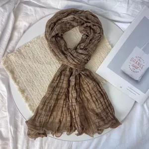 Close-up detail of the brown wrinkled gauze scarf, featuring breathable texture and aesthetic style.