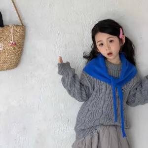 Detail view of kids knit sweater and blue scarf set, soft texture, Korean fashion style outfit.