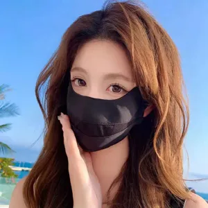 Close-up detail of the breathable black sun protection mask worn outdoors in summer.