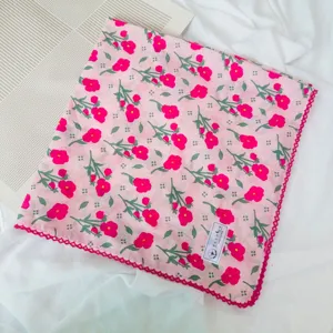 Detailed view of a pink floral cotton bandana with delicate lace trim, perfect for spring.