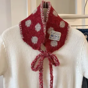 Knit polka dot detachable collar scarf detail showcasing soft wool texture and cute bow tie.