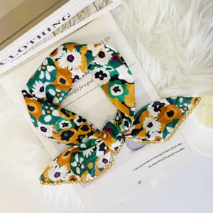 Detailed view of the vintage floral patterned square scarf, soft fabric close-up.