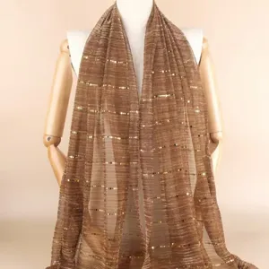 Detailed view of the elegant brown sequin gauze scarf, featuring shimmering gold stripe details.