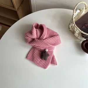 Closeup of soft pink knit winter scarf with cute star decor for kids cozy wear.