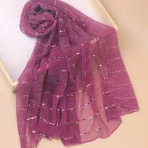Close-up detail of the purple sequin gauze scarf texture, sparkling design for autumn style.