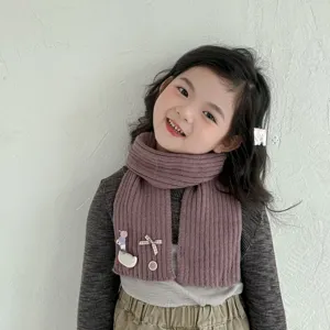 Charming kids knitted winter scarf featuring a cute duck and bow. Soft, thick, and warm.