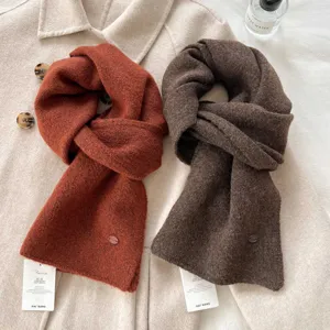 Detail shot of winter cozy knitted thick scarves in brick red and dark brown colors for cold days.