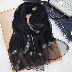 Elegante black long scarf with shimmering gold glitter border, ideal for summer sun protection.