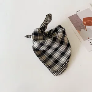 Infant black and white plaid bandana scarf, lightweight cotton sun protection accessory.