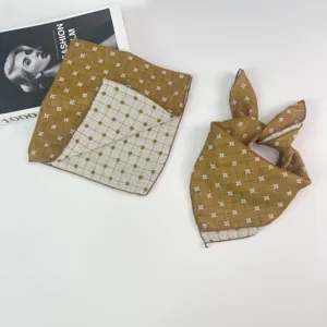 Detail view of mustard yellow checkered baby kerchief, double-sided thin cotton fabric scarf.