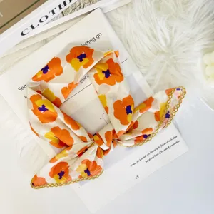 Close-up detail of the floral print small square scarf with elegant gold lace trim design.