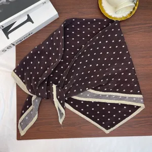 Close-up of a vintage brown pleated polka dot square scarf with beige border details.