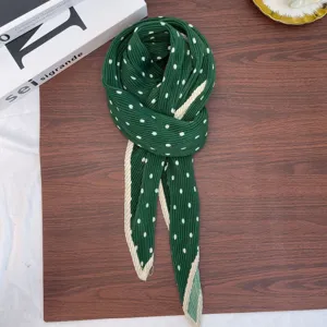 Detailed view of the dark green pleated polka dot square scarf with retro style.