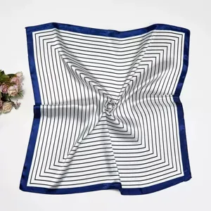 Close-up detail of the 60cm black white striped silk scarf with deep blue border, office style.
